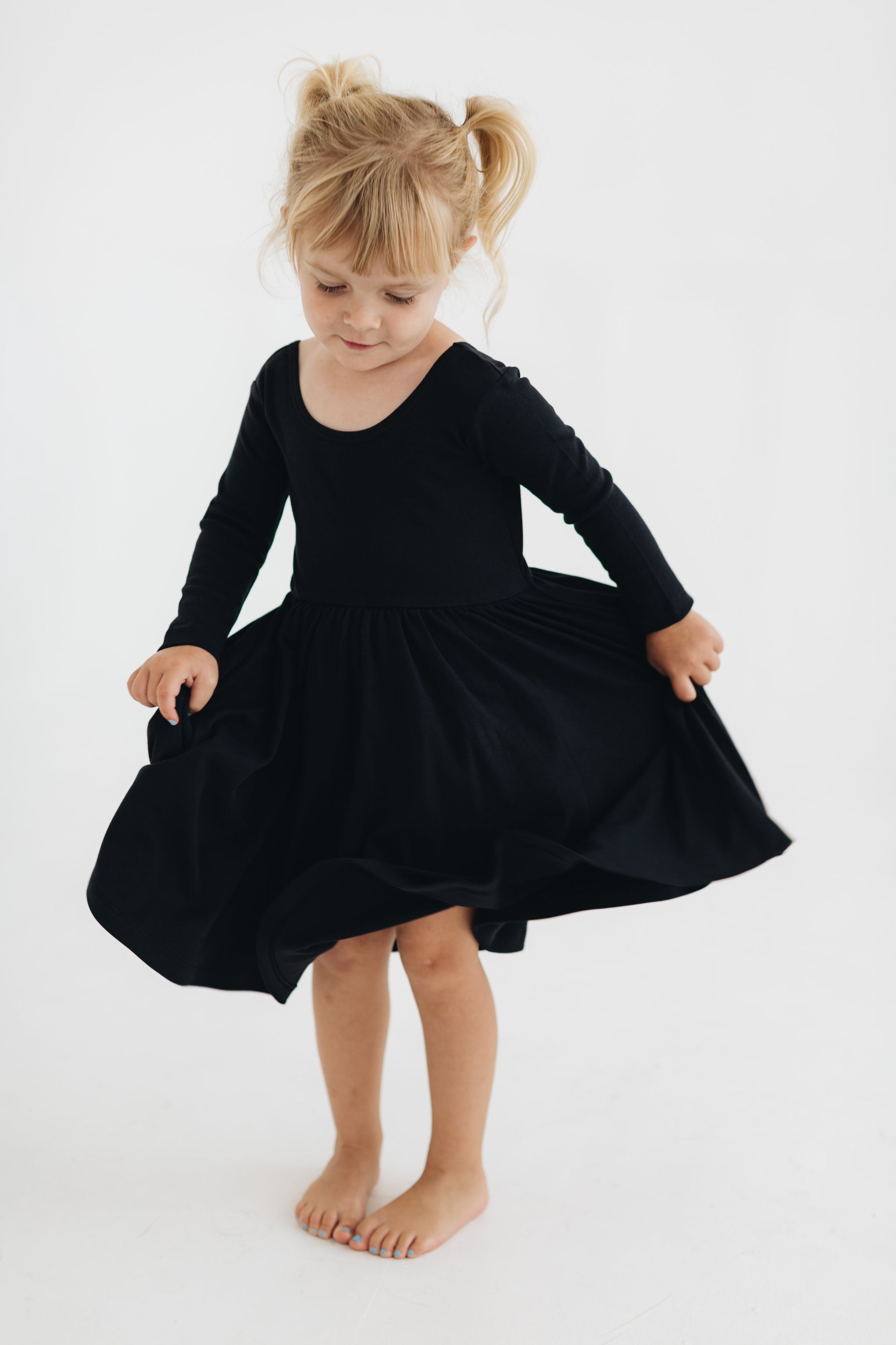 black dress toddler girl Bamboo Long Sleeve Tiered Dress in Midnight by Kyte Baby main image 1